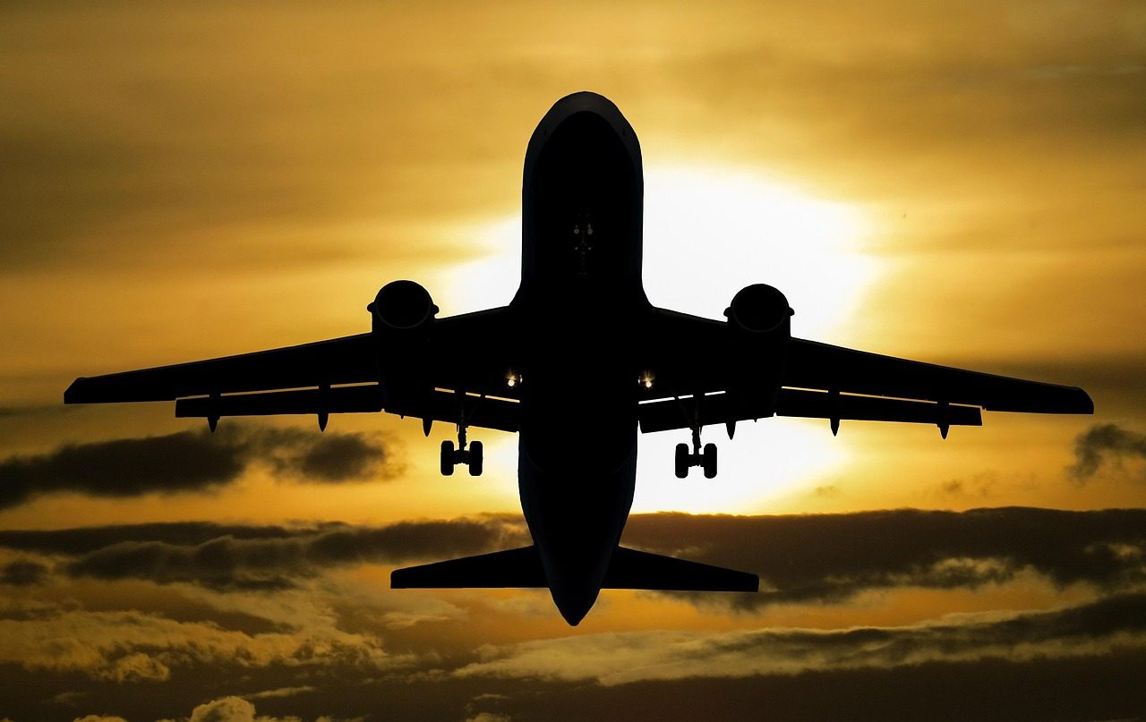 Canada eTA for Filipino citizens: a jet in silhouette climbing into a golden sunset sky