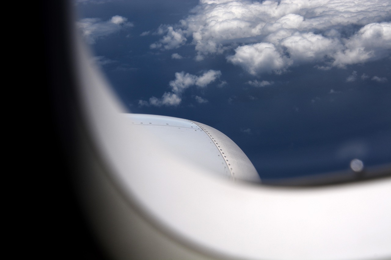 Canada eTA for Irish citizens: an aircraft engine and white clouds seen through a cabin window
